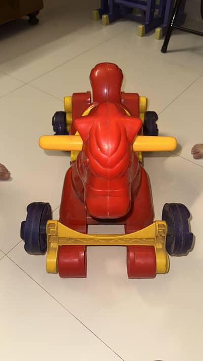 Red swing horse.