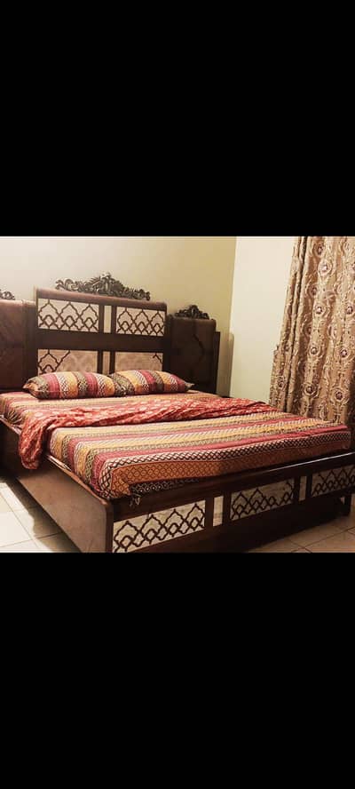 wooden bed with side tables