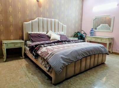 Upholstered King size bed with chalk finished tables and dresser.