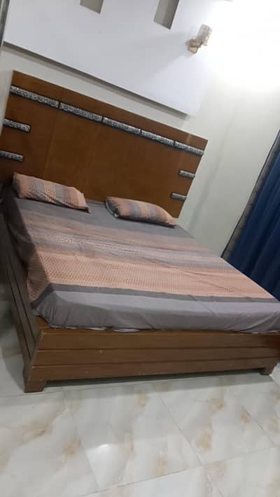 heavy wooden bed with heavy foam mattress