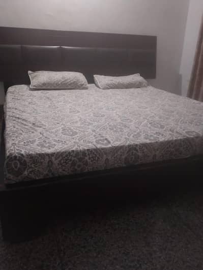 bed with side tables and L shape dressing table