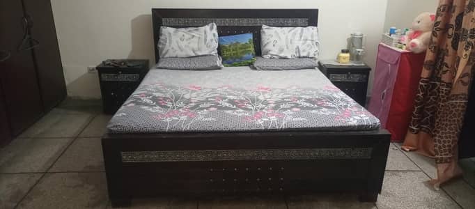 double bed with mattress sides table and dressing