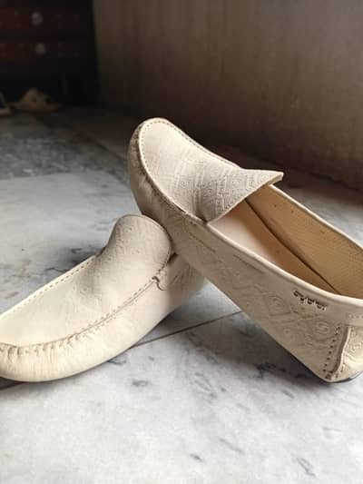 Pair of off white loafers