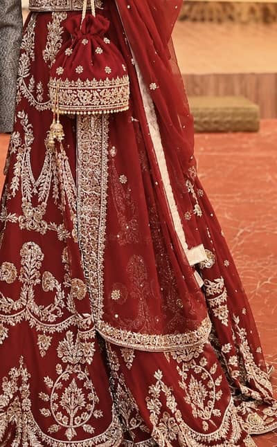 Maroon Bridal Lehenga with Heavy work & Matching Pouch