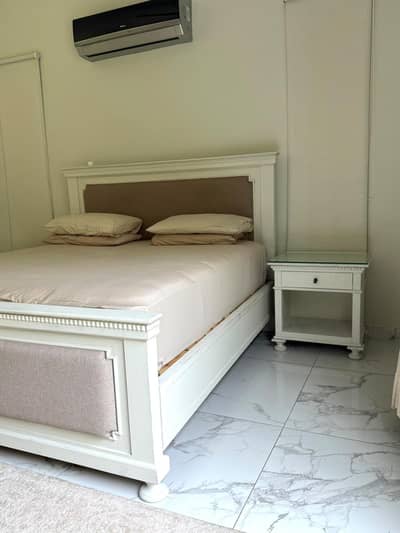 Solid wood , king size bed with two side tables.