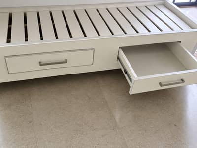 Single wooden bed without mattress