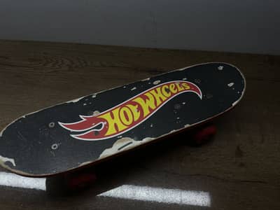 Wooden board, bright red wheels and visible mounting screws.