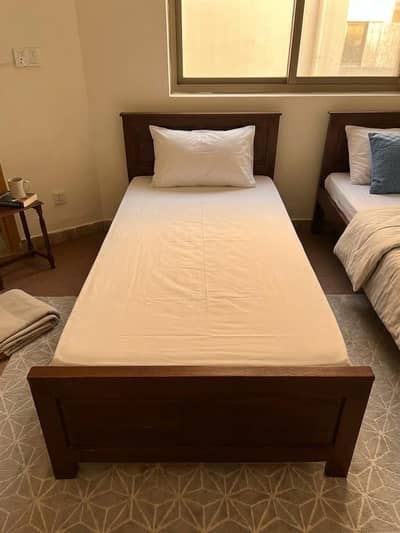Two wooden single bed with mattress