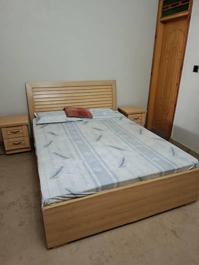 Complete bed set with mattress, side tables, and wardrobe.