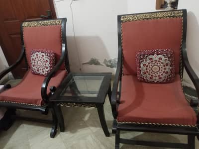 Traditional wooden armchair with red cushions