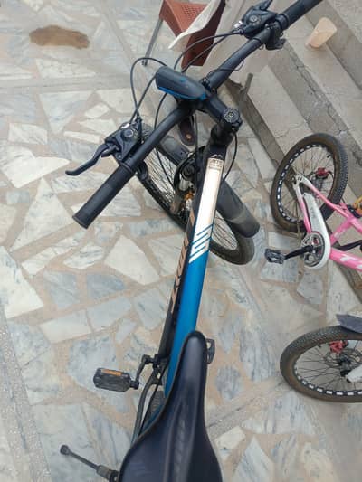 26 inch Mountain bike with small pink bike