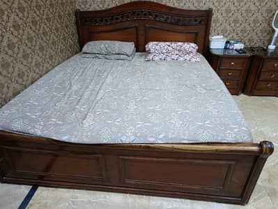 wooden bed with two side table