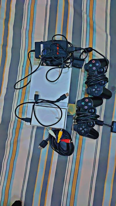 Sony PlayStation 2 (PS2) with 2 Controllers – Good Condition and games