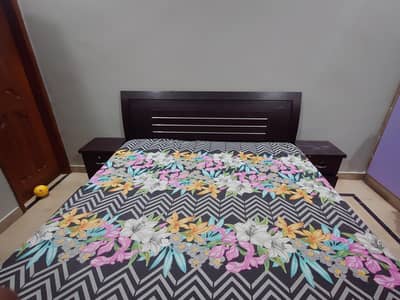 double bed with 2 side table and dressing table