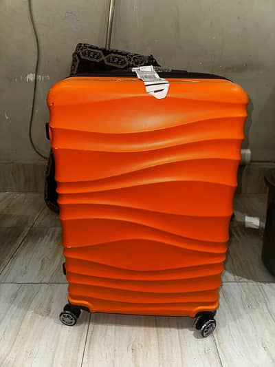 Vibrant Orange Hard-Shell Wavy Spinner Suitcase