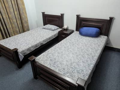 2 Single Beds With Mattresses And Side Tabel