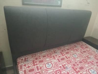 A beautiful English bed with mattress and two side table