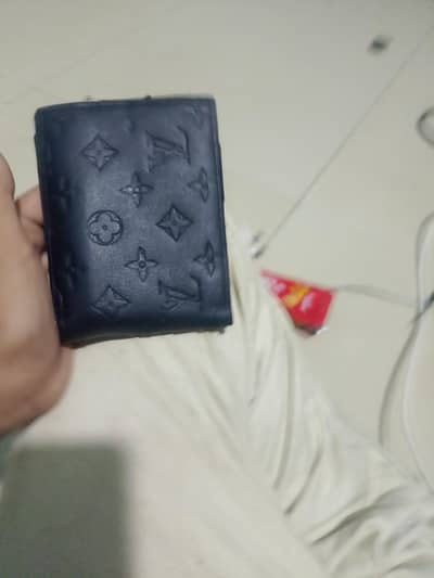 black embossed Louis Vuitton monogram leather wallet.