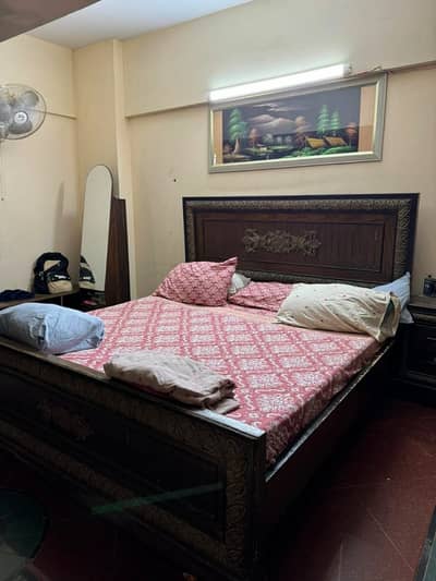 Bed with wardrobe and one side table