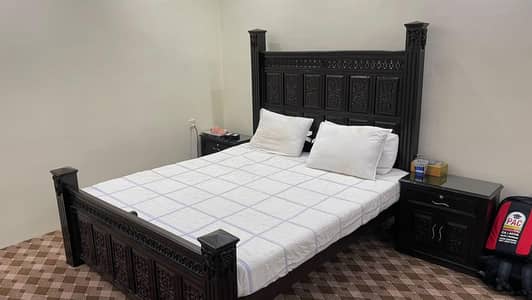 genuine wood double bed with vanity and side tables.