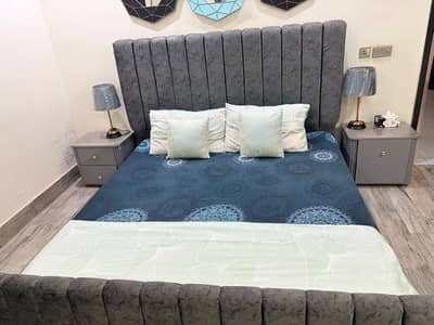 Double bed with 2 side tables and a dresser