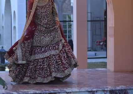 Deep maroon bridal dress with antique gold embroidery