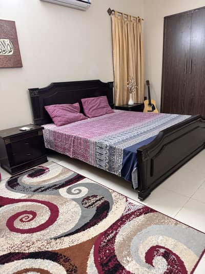 King size bed with spring mattress two side tables n a dressing table