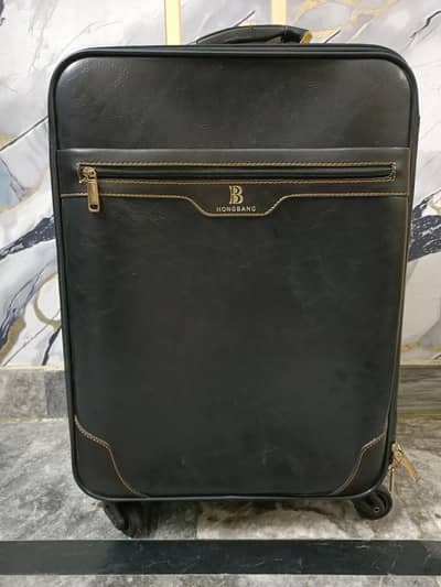 leather trolley bag with gold colored detailing