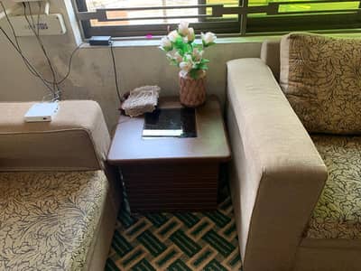 7 seater Sofa and 3 wooden tables.