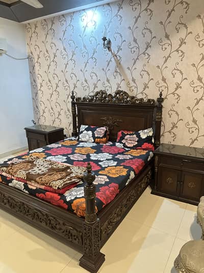 Wooden bed with side tables and dressing table