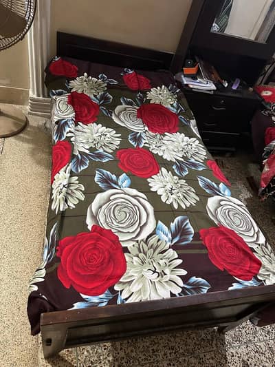single wooden bed with foam mattress