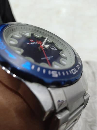 silver and blue dial watch