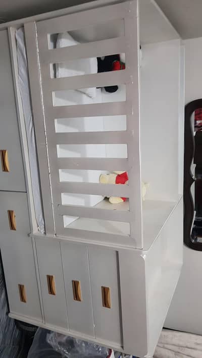 white baby crib with 7 draws in it