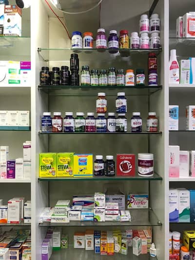Pharmacy setup shelves , counters & fridge for sale in good condition