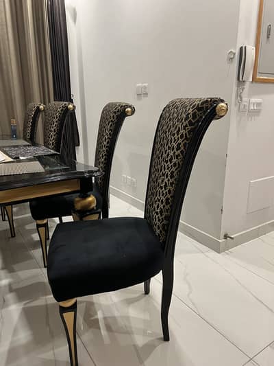 Gourmet 8-Seater Dining Table & Chairs along with black Velvet couch.