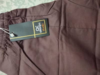 Alkaram trouser brown in color , khaddi trouser grey Available