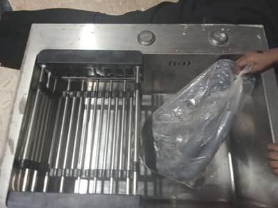kitchen sink with basket and drainage pipe