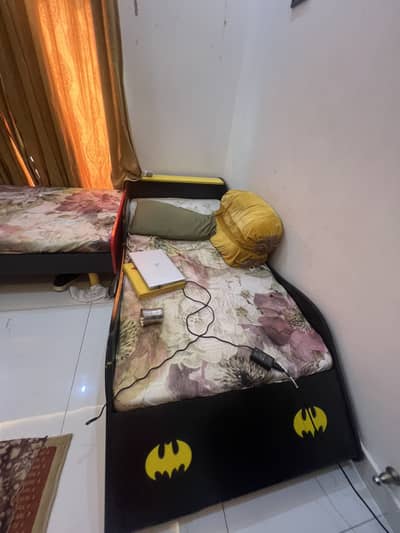 A car shaped single bed along mattress with built in lights