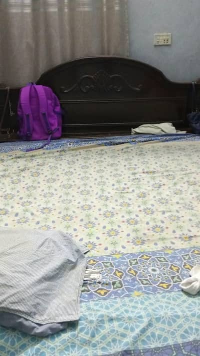 wooden king size bed with new sheets and mattress