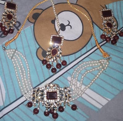 net ka dress hai. or sth ma jewellery bi hai.