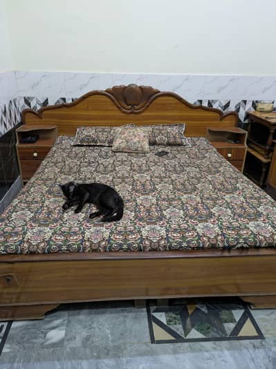 king size bed with two side tables dressing table and showcase