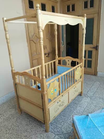 baby cot and wooden swing