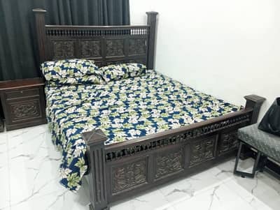 king size bed with side table and dressing table