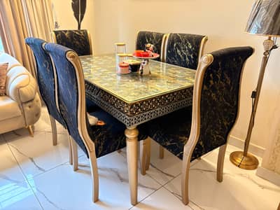 Luxury black and gold dining table with velvet long chairs