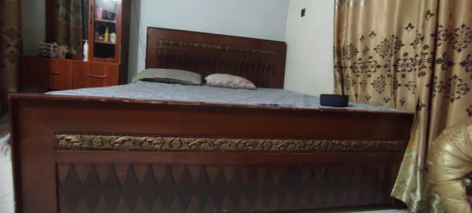 Wooden double bed and wall munted dressing mirror with rolling stool