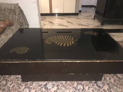 Black and golden glass top center table for sale