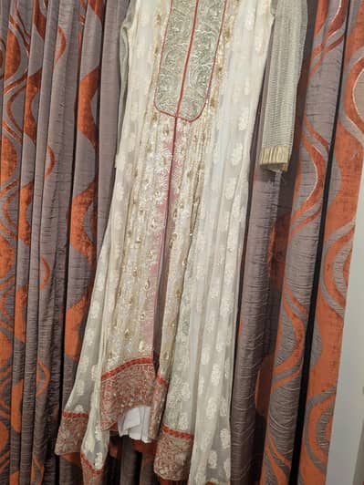white long frock golden kaam on it