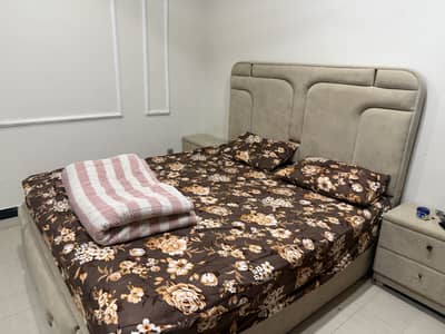 Bed with bedside table