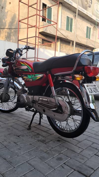 Honda CD 70, 2021 model, red colour available for sale in Lahore.