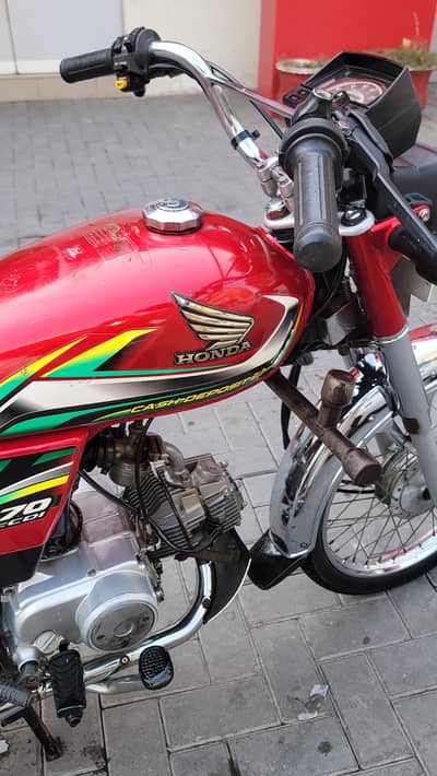 Honda CD 70, 2022 model, red colour available for sale in Lahore.